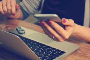 Woman holding silver iPhone 6